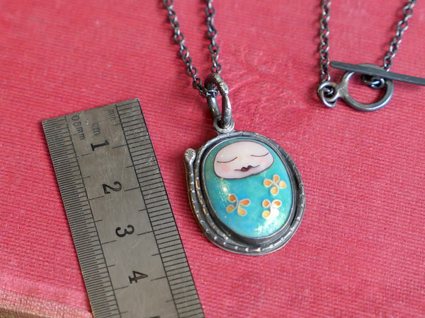 Turquoise Sleeping Baby Pendant with Snakes and Flowers