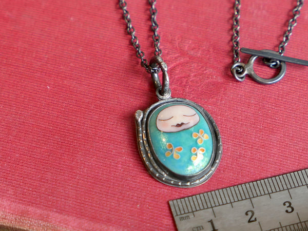 Turquoise Sleeping Baby Pendant with Snakes and Flowers
